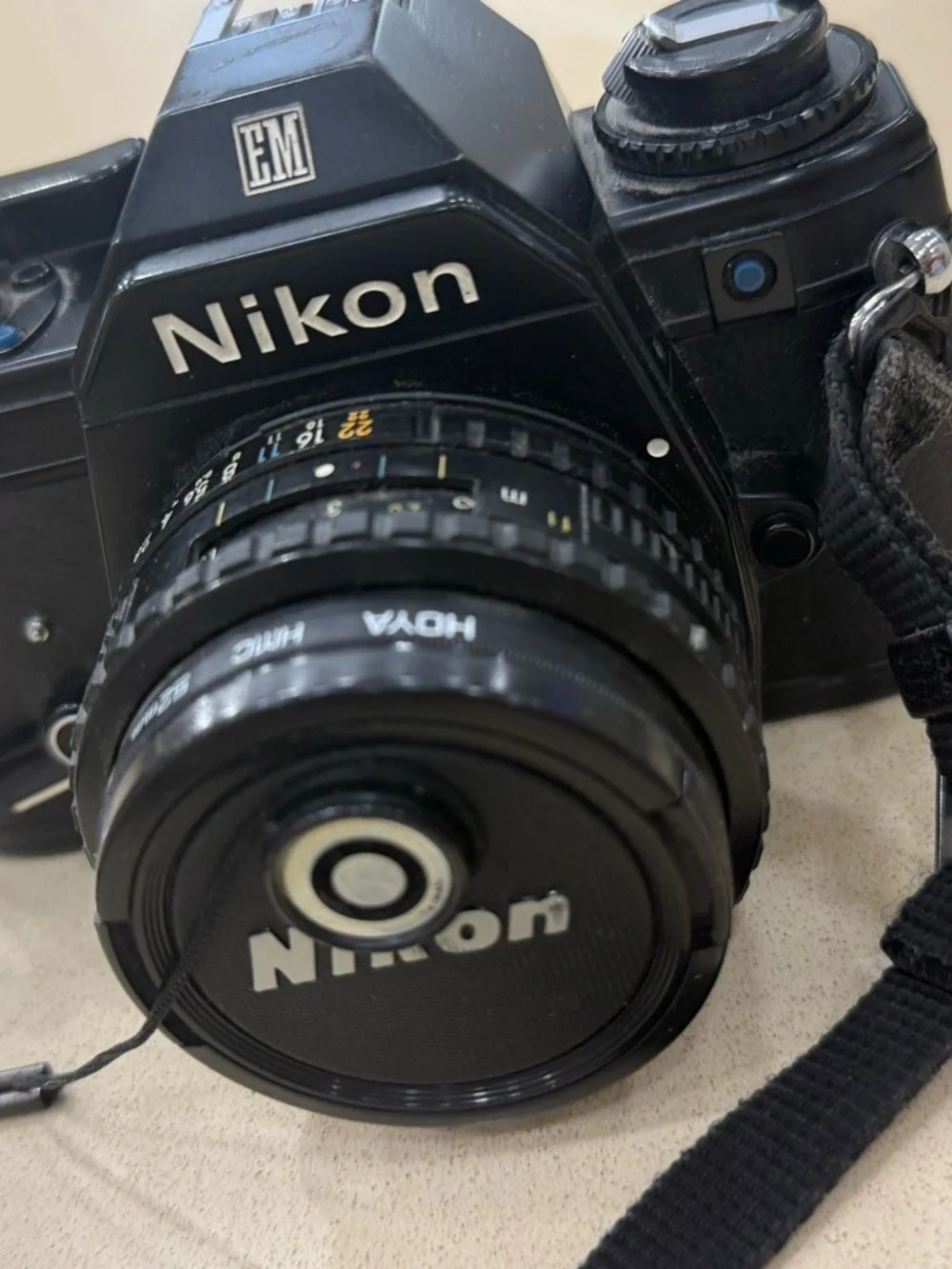 Nikon Black 35mm SLR Camera with Attached Lens and Strap